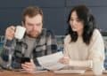 Photo by Mikhail Nilov from Pexels: https://www.pexels.com/photo/a-man-looking-at-the-paper-while-holding-a-coffee-and-phone-6963043/