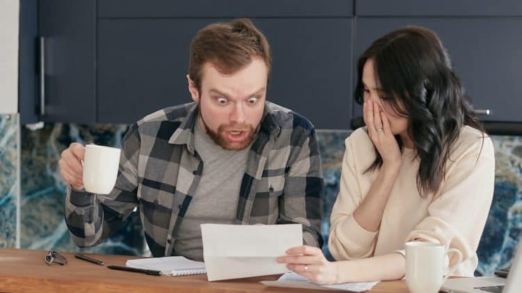 Photo by Mikhail Nilov: https://www.pexels.com/photo/a-couple-sitting-near-the-wooden-table-while-looking-at-the-document-in-shocked-emotion-6963032/
