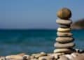 Photo by Pixabay: https://www.pexels.com/photo/cairn-stones-and-body-of-water-in-distance-235990/