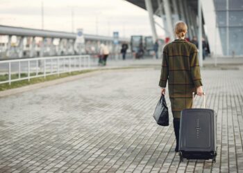 Photo by Gustavo Fring: https://www.pexels.com/photo/unrecognizable-woman-with-suitcase-walking-near-airport-terminal-3885529/