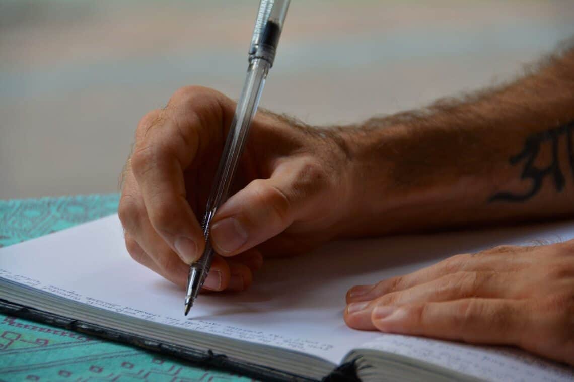 Photo by Pixabay: https://www.pexels.com/photo/man-writing-in-a-book-159774/