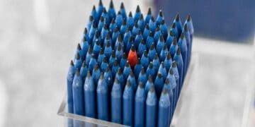 Photo by aboodi vesakaran: https://www.pexels.com/photo/box-of-blue-pencils-with-a-standing-out-single-red-pencil-in-the-middle-18889472/