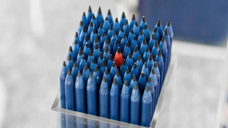 Photo by aboodi vesakaran: https://www.pexels.com/photo/box-of-blue-pencils-with-a-standing-out-single-red-pencil-in-the-middle-18889472/