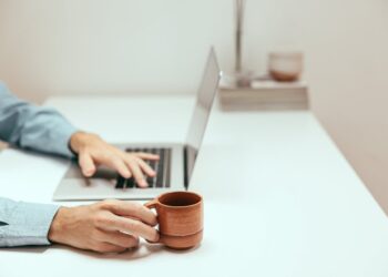 Photo by Cup of  Couple: https://www.pexels.com/photo/a-person-holding-a-cup-while-using-a-laptop-8472565/