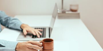 Photo by Cup of  Couple: https://www.pexels.com/photo/a-person-holding-a-cup-while-using-a-laptop-8472565/