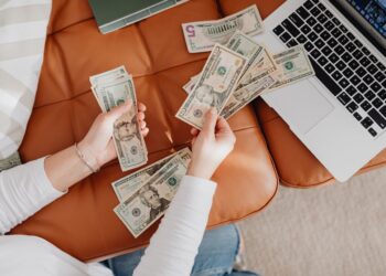 Photo by Photo By: Kaboompics.com: https://www.pexels.com/photo/close-up-of-woman-counting-dollar-bills-5902919/