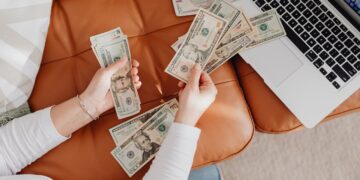 Photo by Photo By: Kaboompics.com: https://www.pexels.com/photo/close-up-of-woman-counting-dollar-bills-5902919/