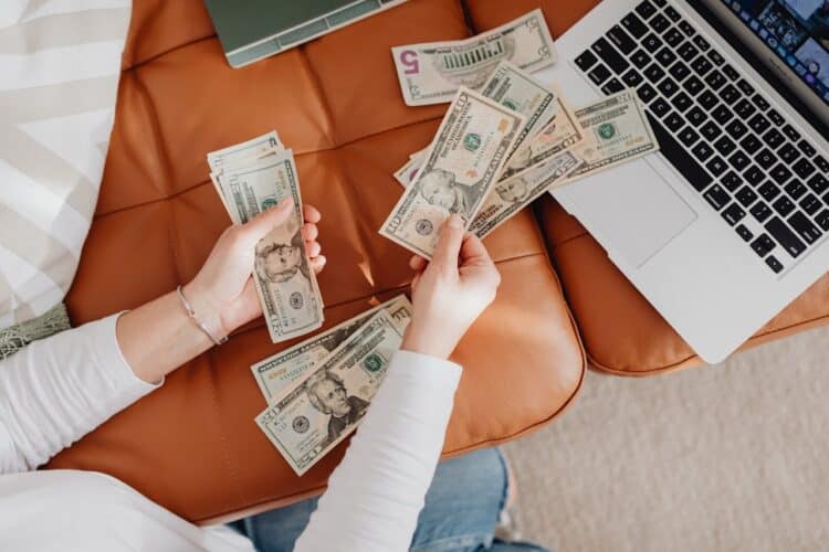Photo by Photo By: Kaboompics.com: https://www.pexels.com/photo/close-up-of-woman-counting-dollar-bills-5902919/