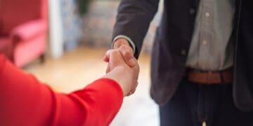 Photo by Kampus Production: https://www.pexels.com/photo/hand-shake-of-man-in-black-suit-jacket-and-woman-in-red-long-sleeves-8439706/