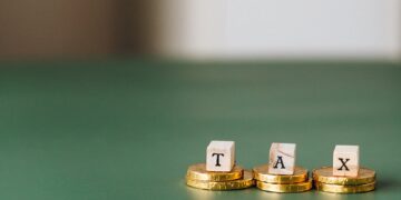 Photo by Nataliya Vaitkevich: https://www.pexels.com/photo/tax-word-on-top-of-gold-coins-6863186/
