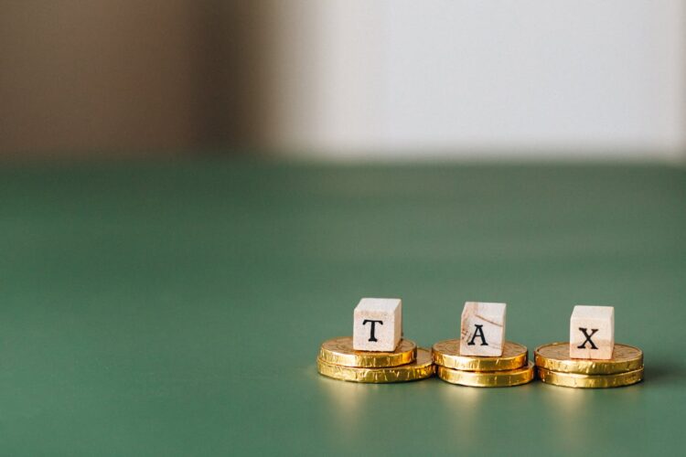 Photo by Nataliya Vaitkevich: https://www.pexels.com/photo/tax-word-on-top-of-gold-coins-6863186/