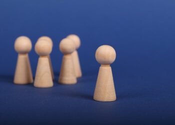 Photo by Ann H: https://www.pexels.com/photo/wooden-person-figures-on-blue-background-6589280/