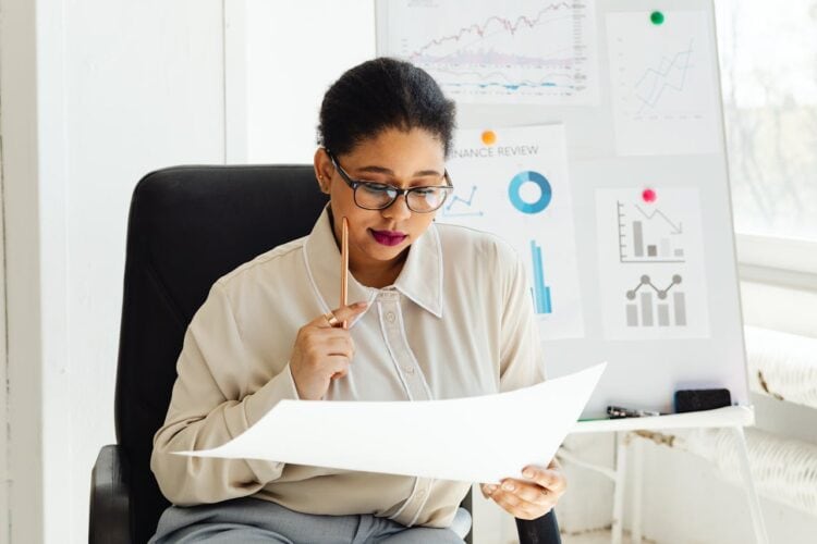 Photo by Photo By: Kaboompics.com: https://www.pexels.com/photo/a-woman-holding-a-white-paper-7876454/