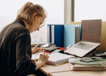 Photo by Mikhail Nilov: https://www.pexels.com/photo/woman-holding-a-pen-reading-notes-in-a-book-binder-8297033/