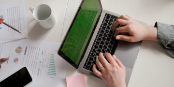 Photo by Alena Shekhovtcova: https://www.pexels.com/photo/a-person-using-a-laptop-8067802/