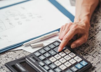 Photo by SHVETS production: https://www.pexels.com/photo/a-person-using-a-calculator-9052475/