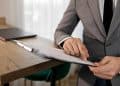 Photo by Alena Darmel: https://www.pexels.com/photo/a-person-in-gray-suit-holding-black-clipboard-7641827/